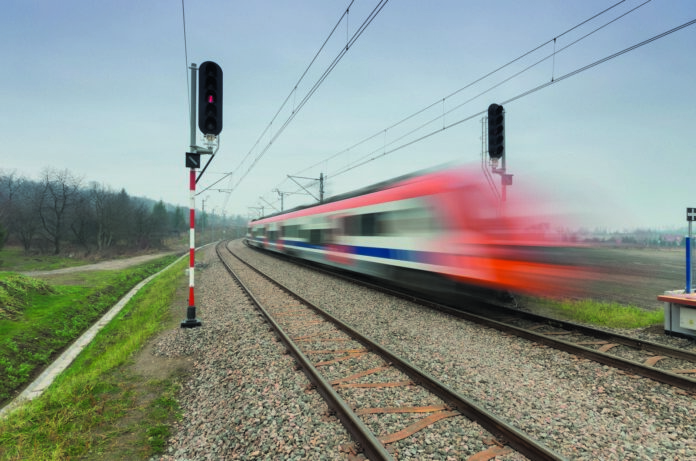 Blurred train of Koleje Malopolskie on double railway track, Kra