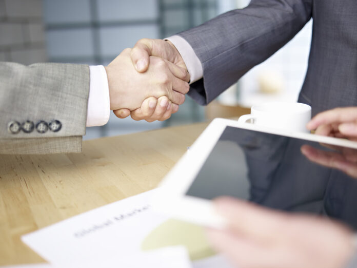 business people shaking hands in office